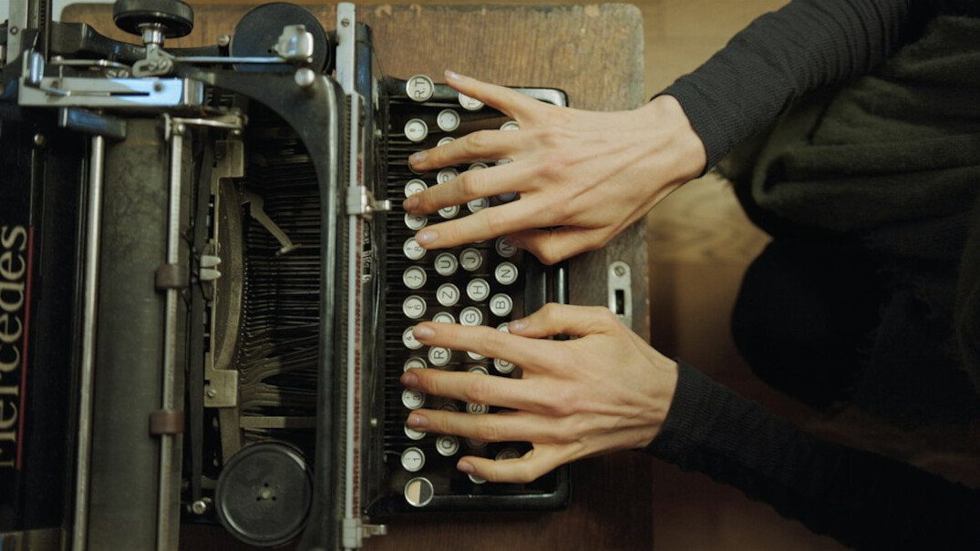 writer typing on typewriter